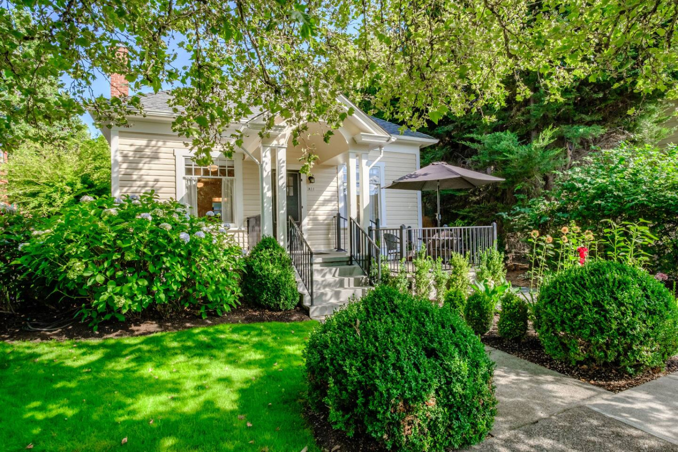 Campus Cottage seen from SW 7th Street, a 1926 furnished home behind a landscaped front garden in Corvallis